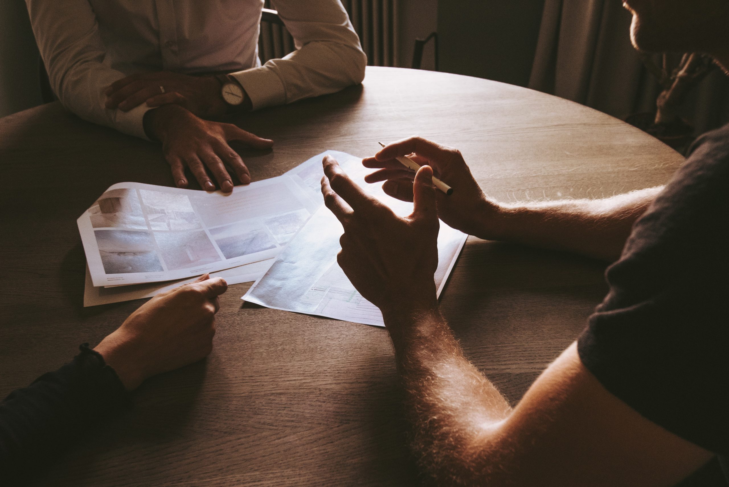 Professional realtor helping clients at table